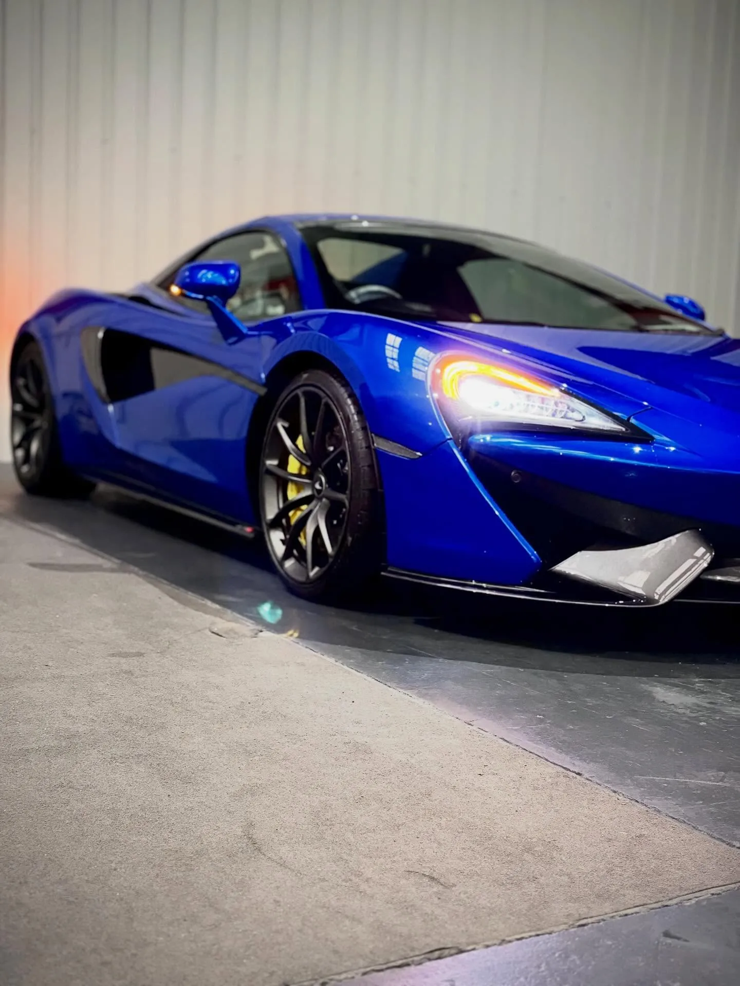 Blue luxury sports car in secure indoor storage facility, Manchester