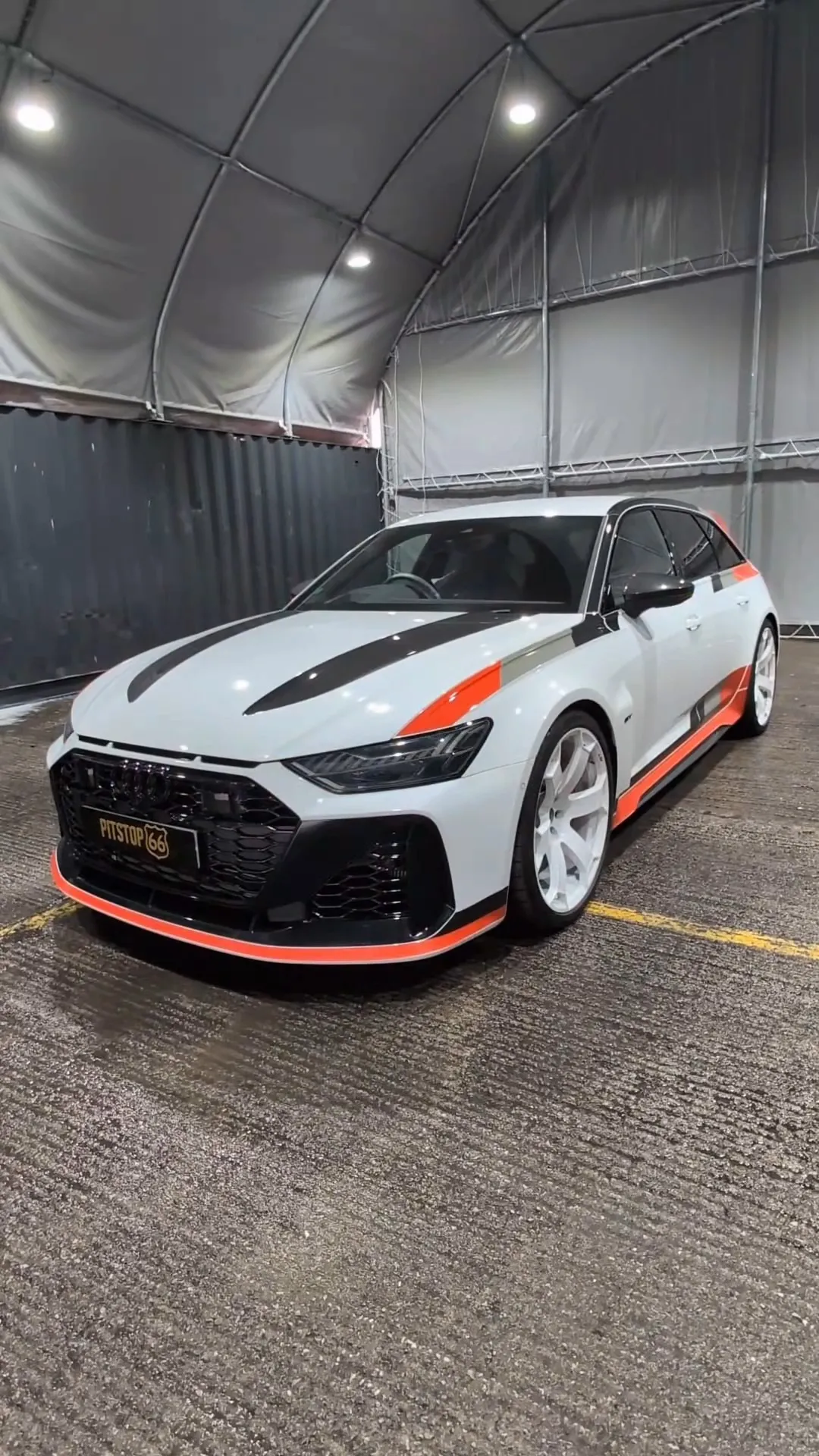 White performance car in secure indoor storage.